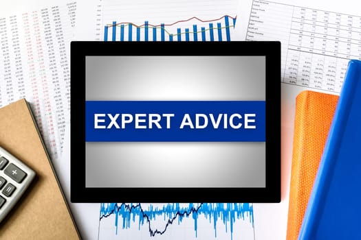 expert advice word on tablet with financial graph background
