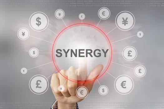 hand pushing synergy button with global networking concept