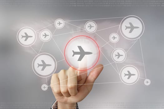 hand pushing flight traveling button with global networking concept