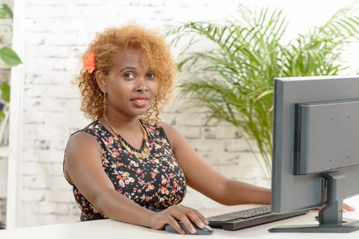 a young  smilling black secretary working with a computer