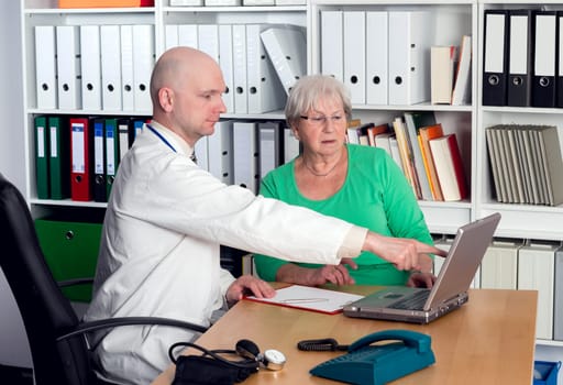 young family doctor in interview with a female senior