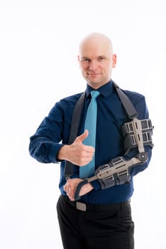 young bald business man with fractured arm and thumb up