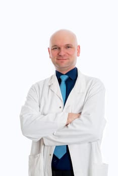 friendly young doctor with crossed arms in front of white background