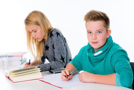 girl and boy learning together in the classroom