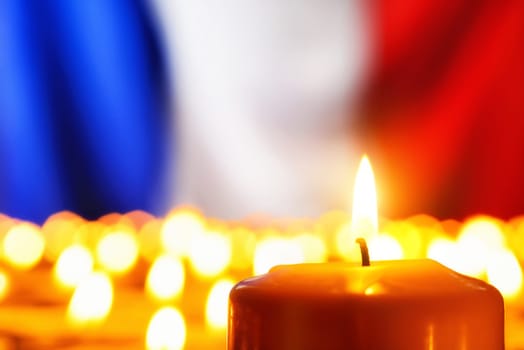 Lots of candles in front of the national colors of France in remembrance of the many victims of terror or to simply symbolize the great French spirit
