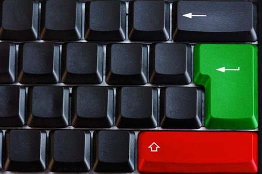 Black computer keyboard with green and red key and arrows