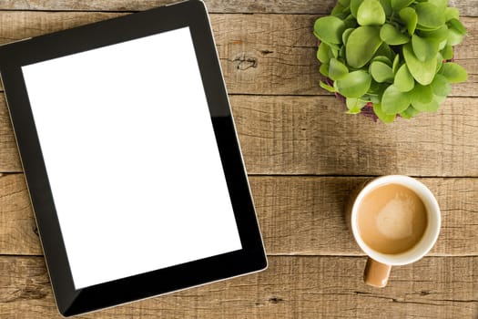tablet white screen display and coffee on wood table