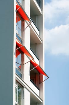 Orange awnings on a white apartment block