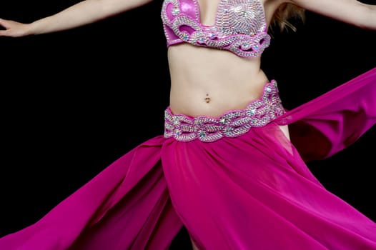 Belly dancer showing abdomen movement while dancing