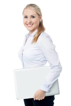 Young female executive carrying laptop