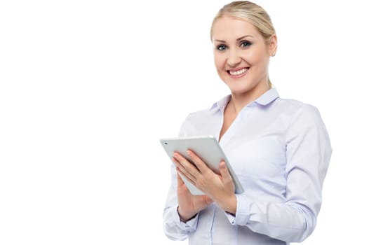 Young beautiful employee surfing on tablet