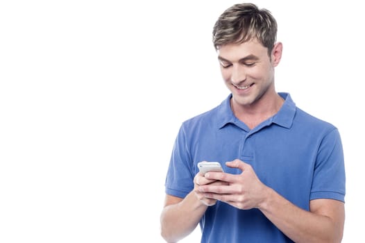 Cool young guy busy on mobile phone