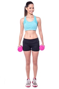 Full length shot of woman with dumbbells