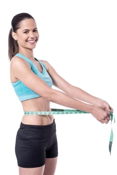 Fir woman with measuring tape around waist