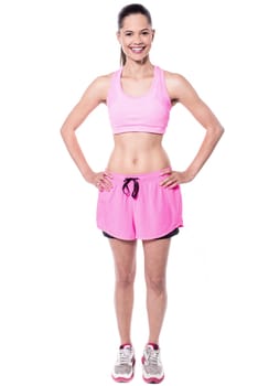 Cheerful fit woman in pink sportswear