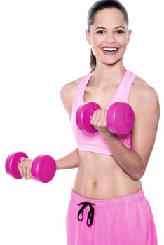Young woman exercising with dumbbells