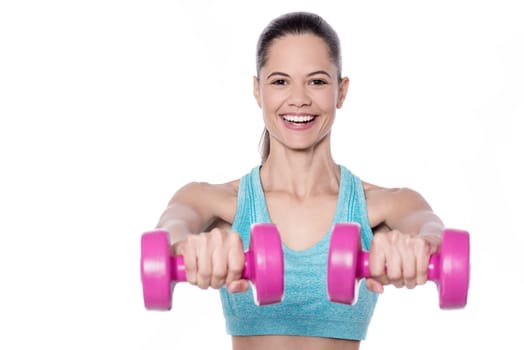 Pretty fit lady exercising with dumbbells