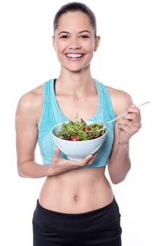 Pretty slim woman eating salad