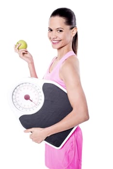 Trainer posing with apple and weigh scale