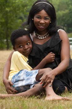African mother with her son in the grass