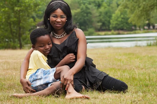 African mother with her son in the grass