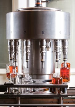 Bottle filling machine filling the bottles with liquor