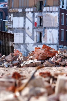 Demolition of residential district in the Netherlands. There is some rubble around a builders skip.