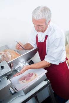 Butcher slicing meat