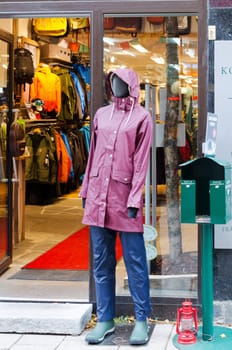 outside the store ther is a doll that shows clothes