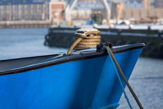 Bow of a blue ship moored in harbor