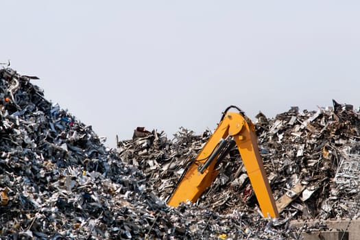 This brand new crawler excavator looks buried in the metal scrap
