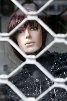 Mannequin dummy locked up in a fashion store