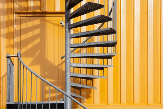 Yellow metal building with spiral metal staircase