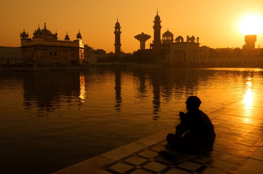 Sikh pilgrims sitting beside the holy pool,Golden Temple,Amritsar,Punjab state,India,Asia