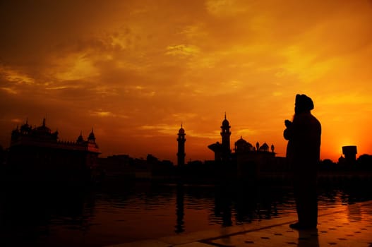 Silhouette of Sikh prayer at golden temple, Amritsar, India