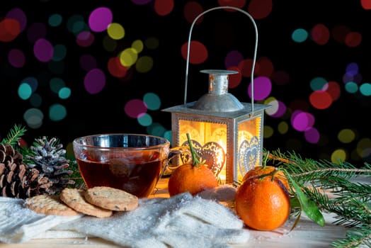 christmas decoration with mandarins and cup of tea