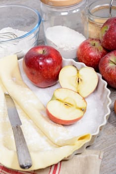 ingredients for the preparation of apple pie , an apple cut in half
