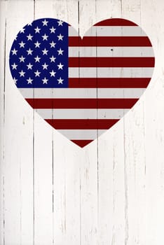 U.S flag in heart shape on a  old white wooden board
