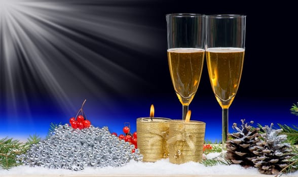 Two glasses of champagne with Christmas decor and two candles