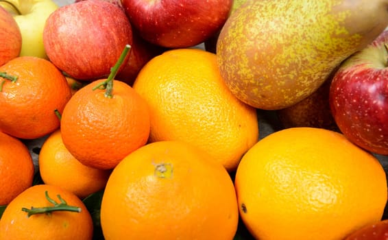 Close-up of various fruits, orange, apple, pear, mandarins