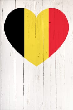 Belgium flag in heart shape on a  old white wooden board