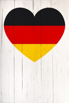 German flag in heart shape on a  old white wooden board