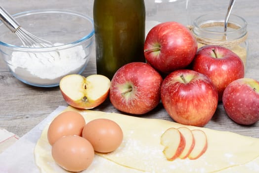 ingredients for apple pie, with flour, apples and ciders
