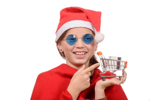 Cute little girl Santa Claus giving credit card and small shopping cart