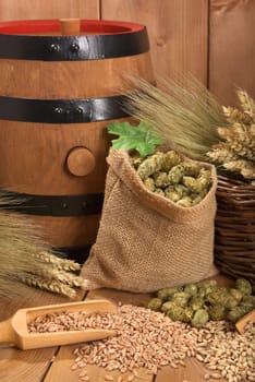 Old beer barrel with wheat,barley,hops and malt