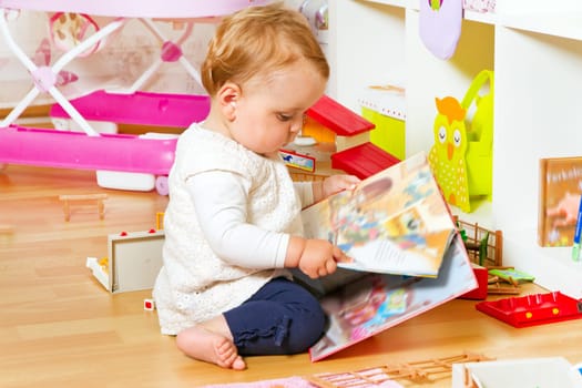 Little baby with picture book