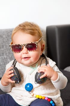 Funny baby with headphones and sunglasses