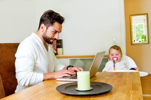 Father works at home on the computer