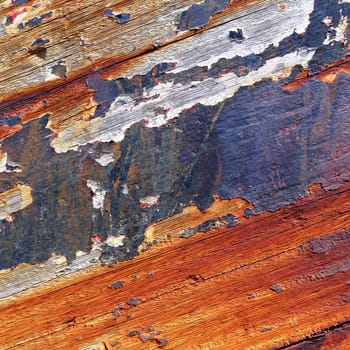 Boards of old boat with peeling paint background texture