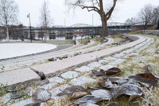 Bridge in Umeå, Sweden with leaves and river.